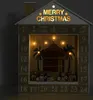 A wooden advent calendar shaped like a house, with a nativity scene inside and illuminated text. Anteprima dell’immagine prodotto