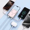 Multiple smartphones and a power bank are shown connected by cables, with a pair of wireless earbuds also connected to a cable. Podgląd zdjęcia produktu