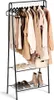 A freestanding garment rack with two shelves, displaying various clothing items and shoes. Produktbild-Vorschau