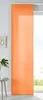 A single orange panel curtain hanging in front of a window.
