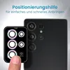 A hand is shown applying a camera lens protector to a smartphone. Produktbild-Vorschau