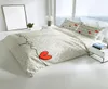 A neatly made bed with a heart-themed duvet cover and pillows, set in a bright, modern bedroom with a large window. Produktbild-Vorschau