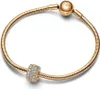 A gold Pandora bracelet with a charm is displayed on a white background. Podgląd zdjęcia produktu