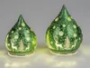 Two green glass Christmas lanterns with reindeer and snowflake designs, lit from within. Produktbild-Vorschau