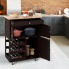 A kitchen cart with various items on it, including pots, bottles, and jars, in a kitchen setting. Produktbild-Vorschau