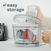 A hand is placing a clear container into a food processor. Produktbild-Vorschau