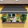 A balcony with plants and an awning. Produktbild-Vorschau