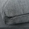 A close-up view of a gray fabric cushion with a partially open zipper. Voir les images du produit