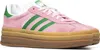 A pair of pink Adidas Gazelle Bold W sneakers with green stripes and a thick gum sole, shown from a side angle against a white background. Produktbild-Vorschau