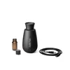 A black aroma diffuser with a small brown bottle and a USB cable on a white background. Náhľad obrázku produktu