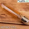 A vintage-style LED light bulb is placed on a wooden surface. Produktbild-Vorschau