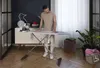 A man is ironing clothes on an ironing board in a room. Podgląd zdjęcia produktu