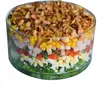 A layered salad in a glass bowl, topped with nuts. Anteprima dell’immagine prodotto