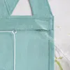 A close-up view of a green fabric curtain with a white string and a clear plastic rod inserted. Produktbild-Vorschau