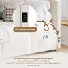A close-up view of a beige upholstered bed frame, highlighting its integrated USB charging ports and a side pocket holding a smartphone. Anteprima dell’immagine prodotto