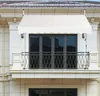 A white awning is installed above a balcony door on a building. Anteprima dell’immagine prodotto