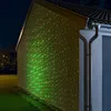 A house wall illuminated by green and red laser lights at night. Anteprima dell’immagine prodotto