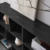 A close-up view of a black bookshelf with several compartments, displaying decorative items and books. Anteprima dell’immagine prodotto