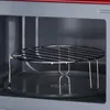 Close-up view of the interior of a microwave oven, showing a wire rack placed on the glass turntable. Produktbild-Vorschau