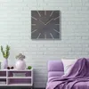 A modern living room scene with a square wall clock above a shelf and a purple sofa. Anteprima dell’immagine prodotto