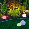 A garden at night with illuminated spherical lights. Produktbild-Vorschau