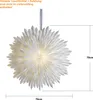 A white paper star lantern with lights inside, suspended by a ribbon. Podgląd zdjęcia produktu