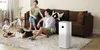 A family and their dog are relaxing in a living room with a Xiaomi air purifier. Produktbild-Vorschau