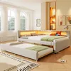 A bedroom scene featuring a modern upholstered bed with an integrated LED headboard and a pull-out trundle bed. Produktbild-Vorschau