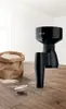 A black Bosch grain mill sits on a wooden table next to a bag of flour and a small sieve. Anteprima dell’immagine prodotto
