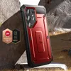 A red and black phone case with a kickstand is displayed on a rocky, outdoor surface. Náhled obrázku produktu