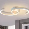 A modern white LED ceiling light fixture with swirling, ribbon-like arms, mounted on a white ceiling. Produktbild-Vorschau