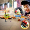 A boy playing with LEGO stunt vehicles. Produktbild-Vorschau