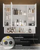 A white bathroom cabinet with doors open, displaying various toiletries and a power outlet. A close-up inset shows the power outlet and a switch. Voir les images du produit