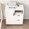 A white cabinet with a printer and books on it, placed next to a desk. Podgląd zdjęcia produktu