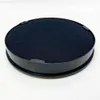 A black circular product with a fabric top sitting on a white surface. Anteprima dell’immagine prodotto