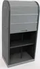 A tall, narrow storage cabinet with a roll-up door and open shelves. Náhled obrázku produktu