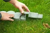 Hands assembling a garden border. Produktbild-Vorschau