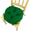 A green round seat cushion on a wooden chair. Produktbild-Vorschau