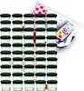 A large group of small glass jars with black lids, arranged in rows, with a packet of jelly powder and a checkered cloth in the background. Podgląd zdjęcia produktu