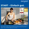 A woman is cooking in a kitchen, with various awards and logos displayed on the wall. Produktbild-Vorschau
