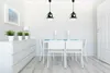 A dining room with a table, chairs, and a dresser. Podgląd zdjęcia produktu