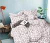 A bedroom scene with a bed dressed in floral bedding. Náhled obrázku produktu