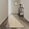 A hallway with a runner rug on a wooden floor. Podgląd zdjęcia produktu