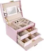 An open pink jewelry box filled with various jewelry items. Náhled obrázku produktu