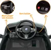 Close-up view of the interior of a toy electric car, highlighting the steering wheel, dashboard, and control buttons. Anteprima dell’immagine prodotto