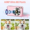 A pink digital camera with a diagram of its lens assembly, and two comparison photos of a dog, one labeled 'Unser 44MP' and the other 'Andere 36MP'. Produktbild-Vorschau