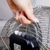 A hand is holding the handle of a fan. Voir les images du produit