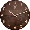 A close-up view of a wooden wall clock with a deer logo and the brand name 'Holzwerk'. Produktbild-Vorschau