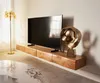 A modern living room with a floating TV stand and a large television. Produktbild-Vorschau