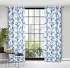 A pair of floral patterned curtains hangs in front of a large window with a city view. Anteprima dell’immagine prodotto